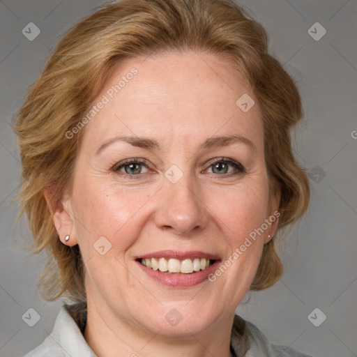 Joyful white adult female with medium  brown hair and grey eyes