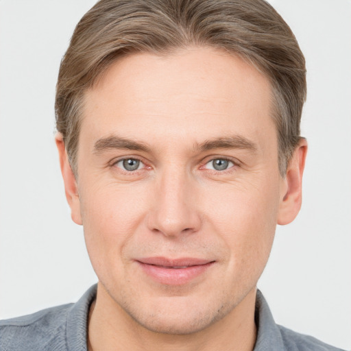 Joyful white adult male with short  brown hair and grey eyes