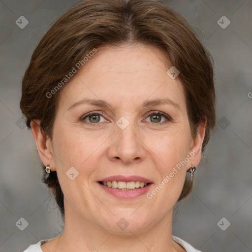 Joyful white adult female with medium  brown hair and grey eyes