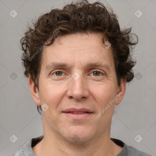 Joyful white adult male with short  brown hair and grey eyes