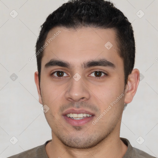 Joyful latino young-adult male with short  brown hair and brown eyes