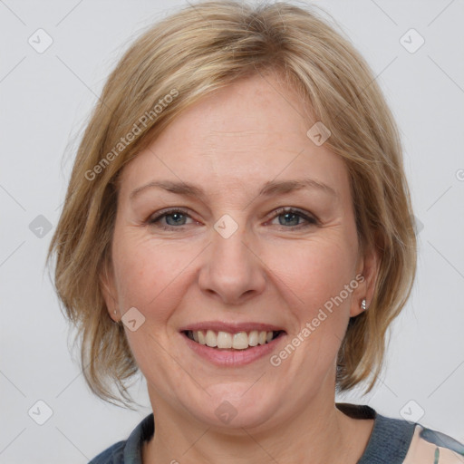 Joyful white adult female with medium  brown hair and grey eyes