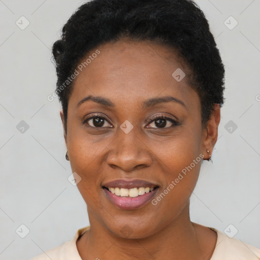 Joyful black young-adult female with short  black hair and brown eyes