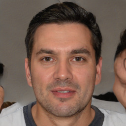 Joyful white adult male with short  brown hair and brown eyes