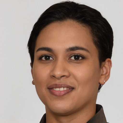 Joyful latino young-adult female with short  black hair and brown eyes