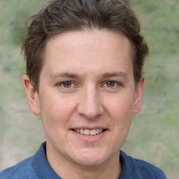 Joyful white adult male with short  brown hair and grey eyes