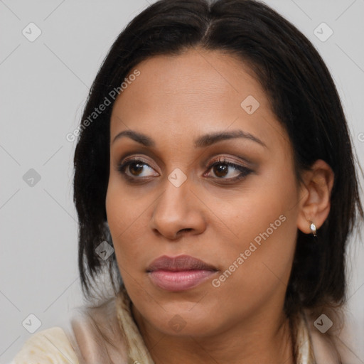 Joyful black young-adult female with long  brown hair and brown eyes