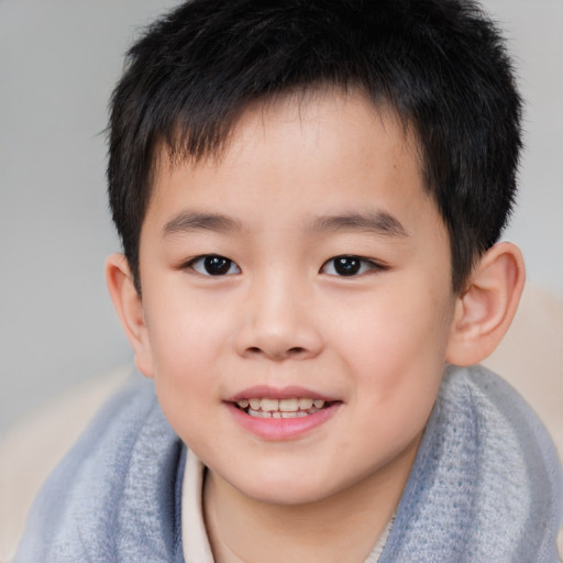 Joyful asian child male with short  brown hair and brown eyes