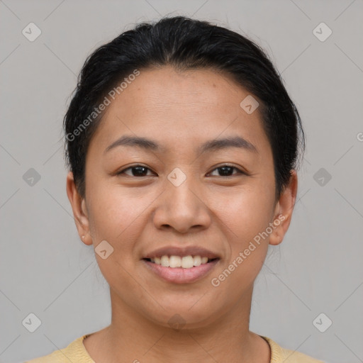 Joyful latino young-adult female with short  brown hair and brown eyes