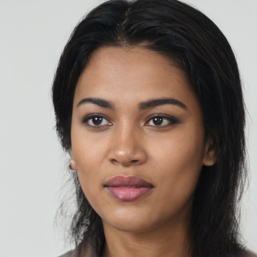 Joyful latino young-adult female with long  black hair and brown eyes