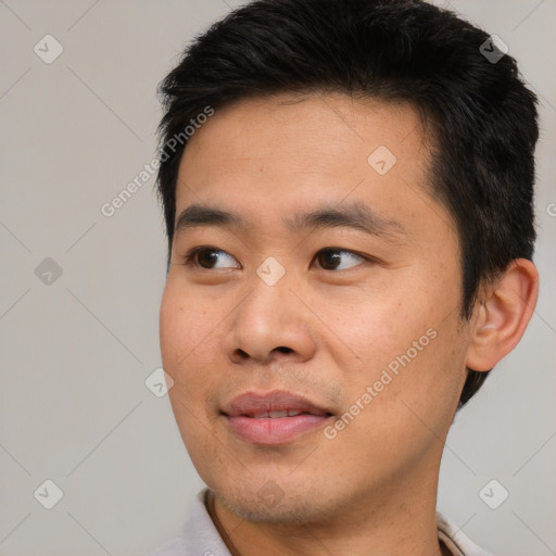 Joyful asian young-adult male with short  black hair and brown eyes