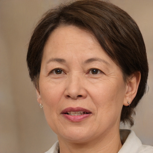 Joyful white adult female with medium  brown hair and brown eyes