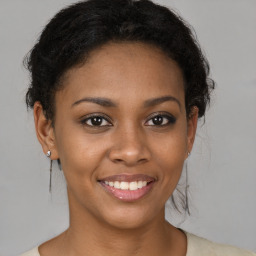 Joyful black young-adult female with short  brown hair and brown eyes