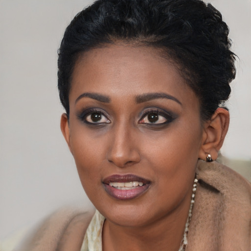Joyful black young-adult female with short  brown hair and brown eyes