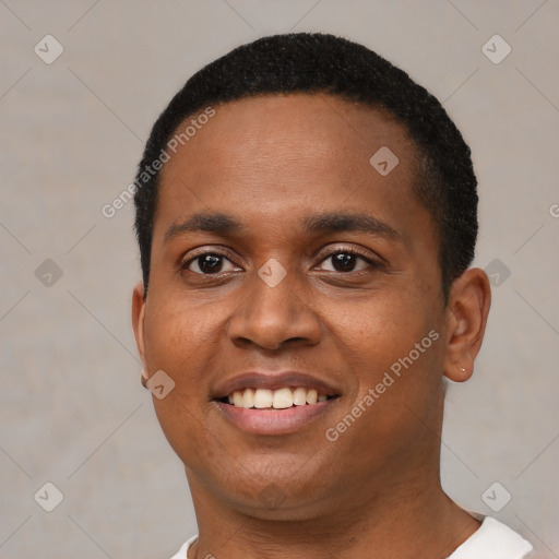 Joyful black young-adult male with short  black hair and brown eyes