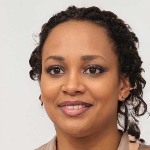 Joyful black young-adult female with medium  brown hair and brown eyes