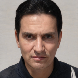 Joyful white adult male with short  black hair and brown eyes