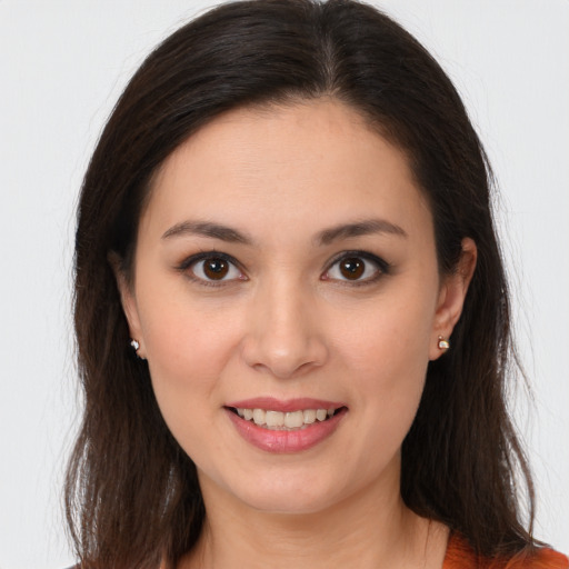 Joyful white young-adult female with long  brown hair and brown eyes