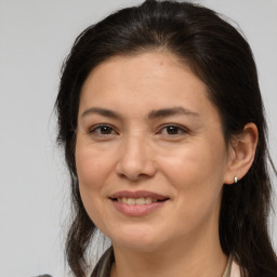 Joyful white adult female with medium  brown hair and brown eyes