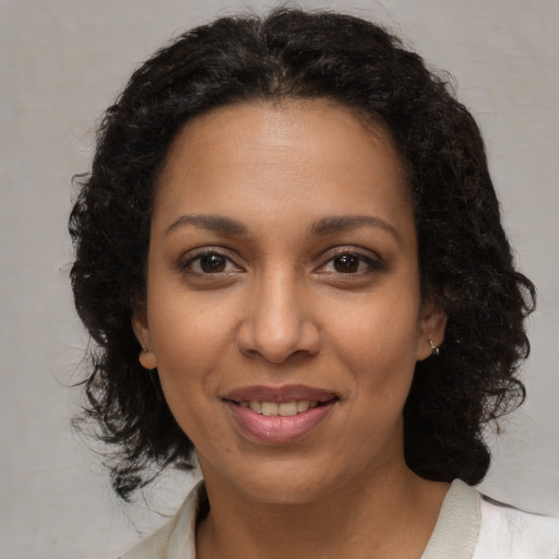 Joyful black young-adult female with medium  brown hair and brown eyes