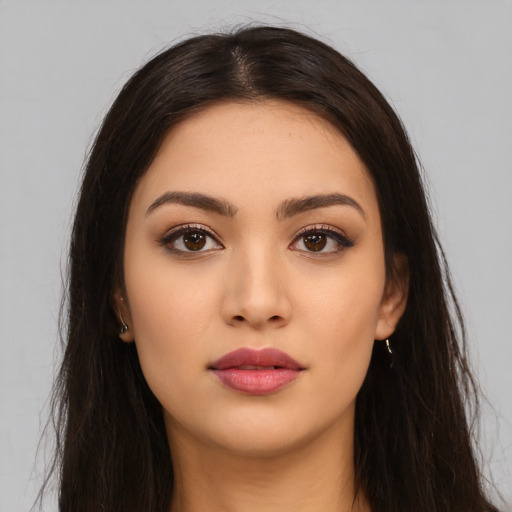 Neutral latino young-adult female with long  brown hair and brown eyes