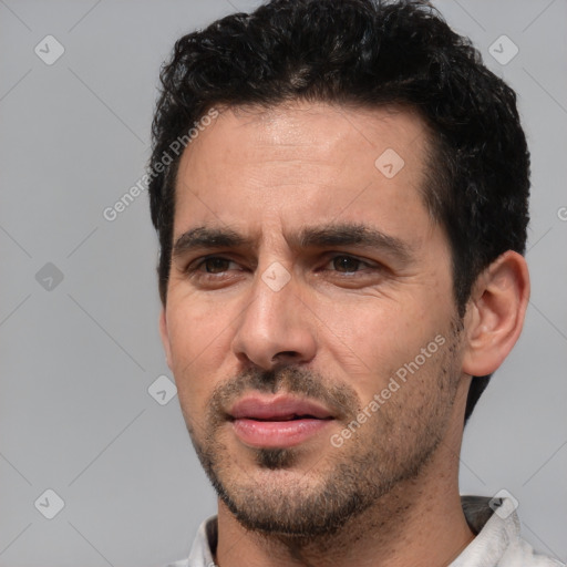 Joyful white young-adult male with short  black hair and brown eyes