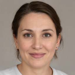 Joyful white young-adult female with medium  brown hair and brown eyes