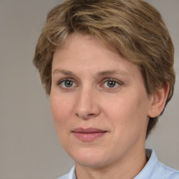 Joyful white adult female with medium  brown hair and grey eyes