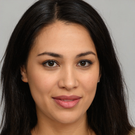 Joyful latino young-adult female with long  brown hair and brown eyes