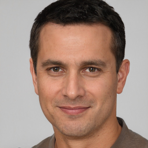 Joyful white adult male with short  brown hair and brown eyes