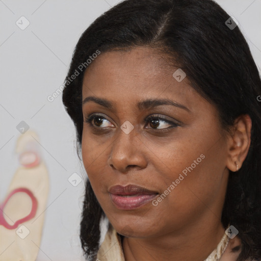 Joyful black young-adult female with long  brown hair and brown eyes