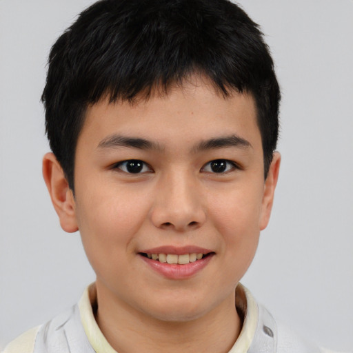 Joyful asian child male with short  brown hair and brown eyes