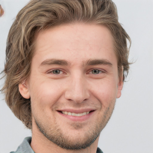 Joyful white adult male with short  brown hair and blue eyes