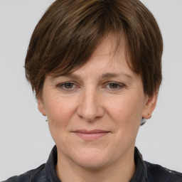 Joyful white adult female with short  brown hair and grey eyes