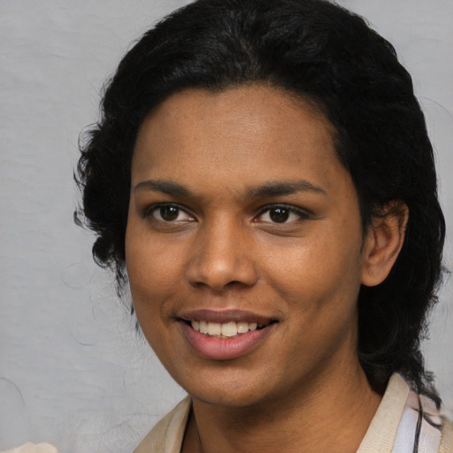Joyful black young-adult female with medium  black hair and brown eyes