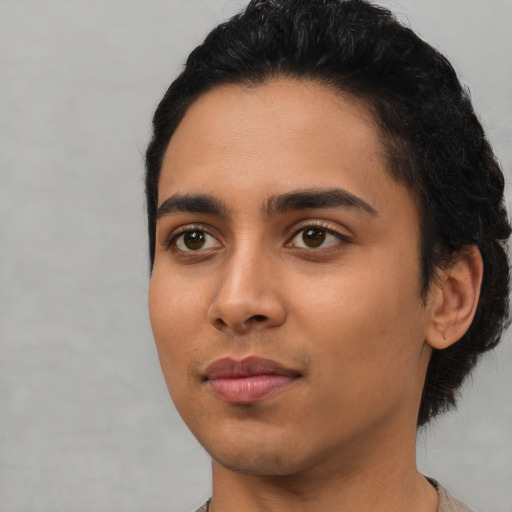 Joyful latino young-adult male with short  black hair and brown eyes