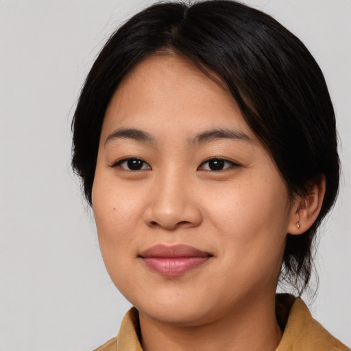 Joyful asian young-adult female with medium  black hair and brown eyes
