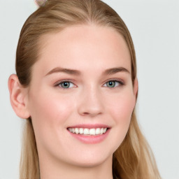 Joyful white young-adult female with long  brown hair and blue eyes