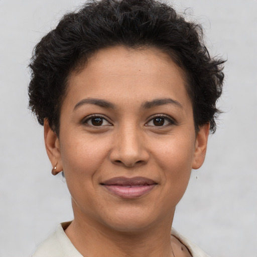 Joyful latino young-adult female with short  brown hair and brown eyes