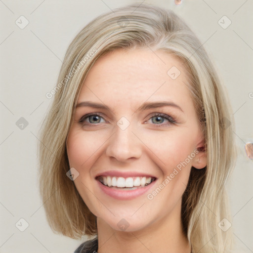 Joyful white young-adult female with long  brown hair and blue eyes