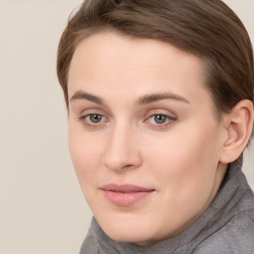 Joyful white young-adult female with long  brown hair and grey eyes