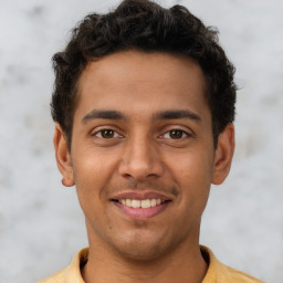 Joyful latino young-adult male with short  brown hair and brown eyes