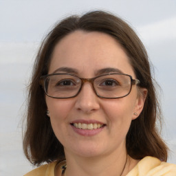 Joyful white young-adult female with medium  brown hair and brown eyes