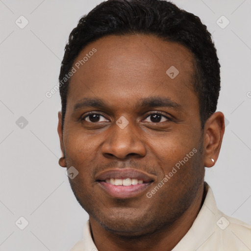 Joyful black young-adult male with short  brown hair and brown eyes