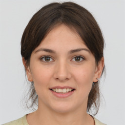 Joyful white young-adult female with medium  brown hair and brown eyes