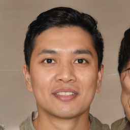 Joyful asian young-adult male with short  black hair and brown eyes