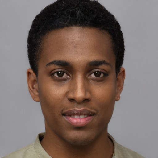 Joyful black young-adult male with short  black hair and brown eyes