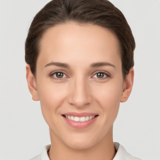 Joyful white young-adult female with short  brown hair and brown eyes