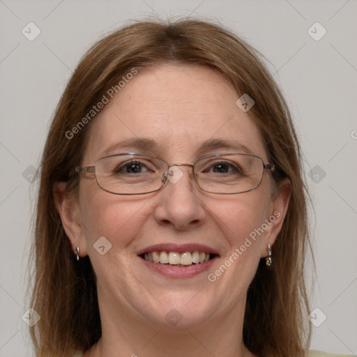 Joyful white adult female with long  brown hair and blue eyes