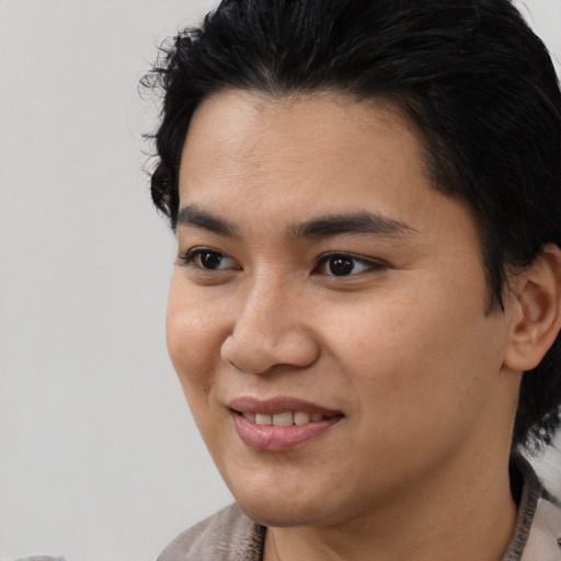 Joyful latino young-adult male with medium  black hair and brown eyes